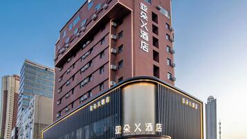A multi-story hotel with a prominent entrance and signage.