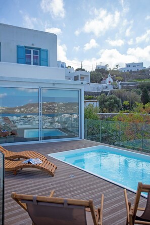 A rooftop pool area with a clear view of the cityscape.