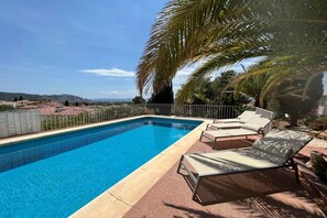 A swimming pool with lounge chairs and a view of the landscape. - Holiday home in Roses with swimming pool (Roses)