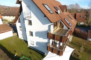 A two-story house with a sloped roof, multiple windows, and a balcony. - Holiday apartment with 3 bedrooms (Meersburg)