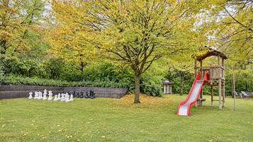 A playground with a slide and a chessboard setup.