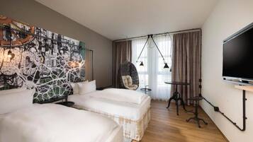 A hotel room with two beds, a hanging chair, a TV, and a wall art piece.