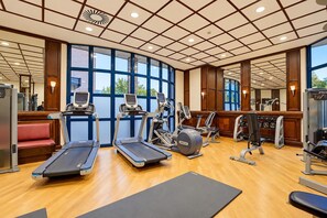 A gym with treadmills, a stationary bike, and weight machines.