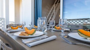 A table set for a meal with plates, cutlery, and a pitcher of water.