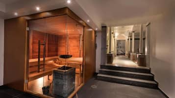 Un interior moderno con sauna, chimenea y una escalera que conduce a otra zona.