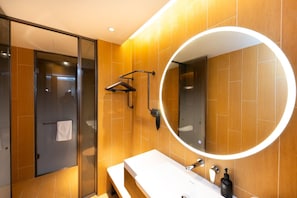 A modern bathroom with a large mirror, wooden wall tiles, a bench, and a towel rack. - Super 8 Hotel Xian Nan Shao Men (Xi'an)