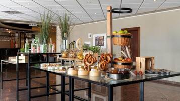 A buffet setup with various food items and beverages.
