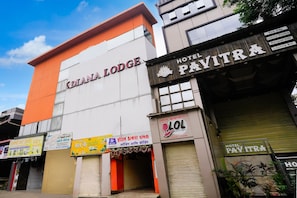 Un hotel llamado 'DIANA LODGE' con carteles que indican 'HOTEL PAVITRA' y 'LOL Family Lounge' a la vista.