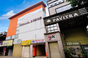 A hotel named 'DIANA LODGE' with signs for 'HOTEL PAVITRA' and 'LOL Family Lounge' visible.