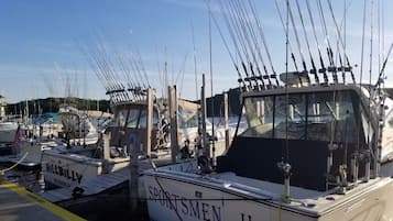 A marina with multiple boats docked, including one named 'SPORTSMEN II'.