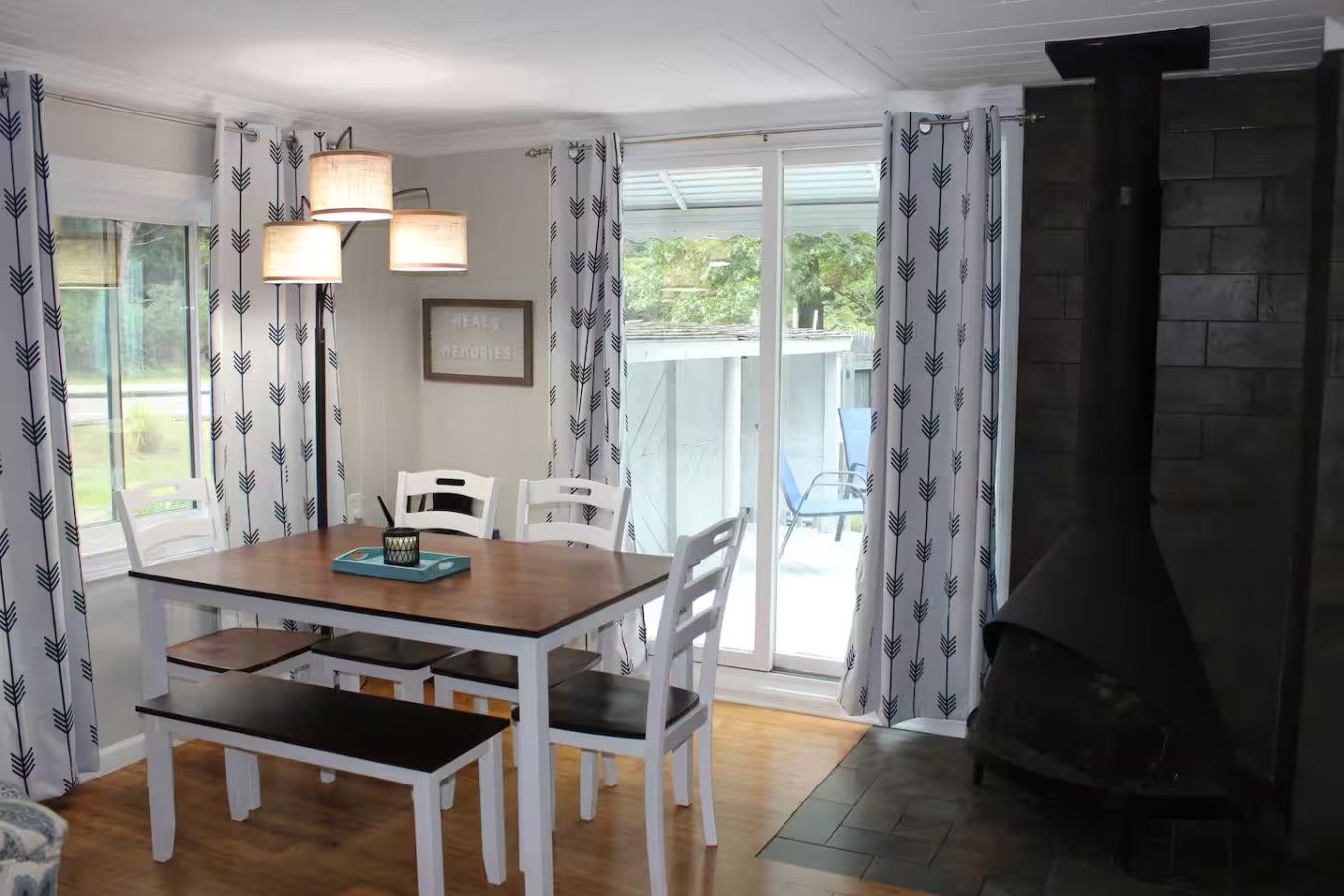 A dining area with a table, chairs, and a fireplace.