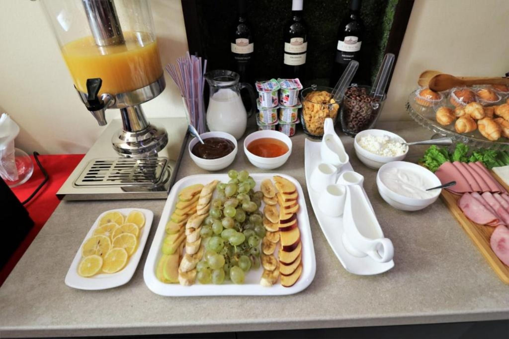 A breakfast buffet with various food items and condiments.