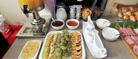 A breakfast buffet with various food items and condiments.