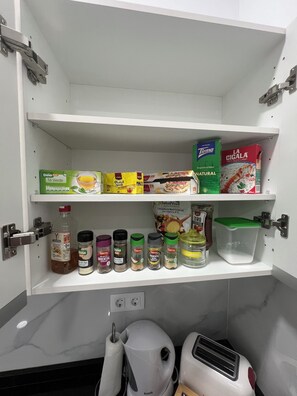 A kitchen pantry with shelves stocked with food items and condiments. - Home and the Ocean in Las Canteras (Unknown)