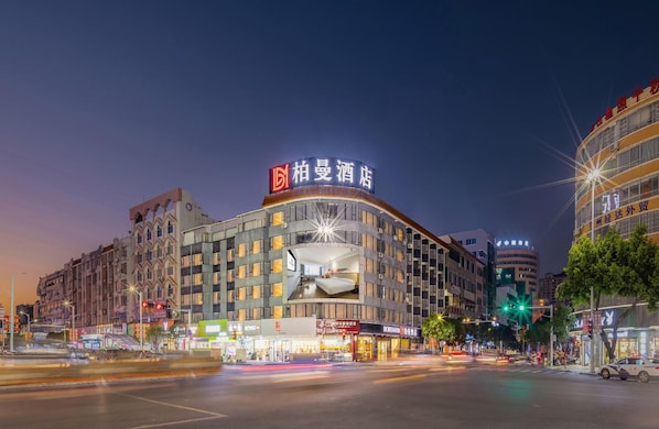 A hotel with a prominent sign, multiple floors, and a modern design.