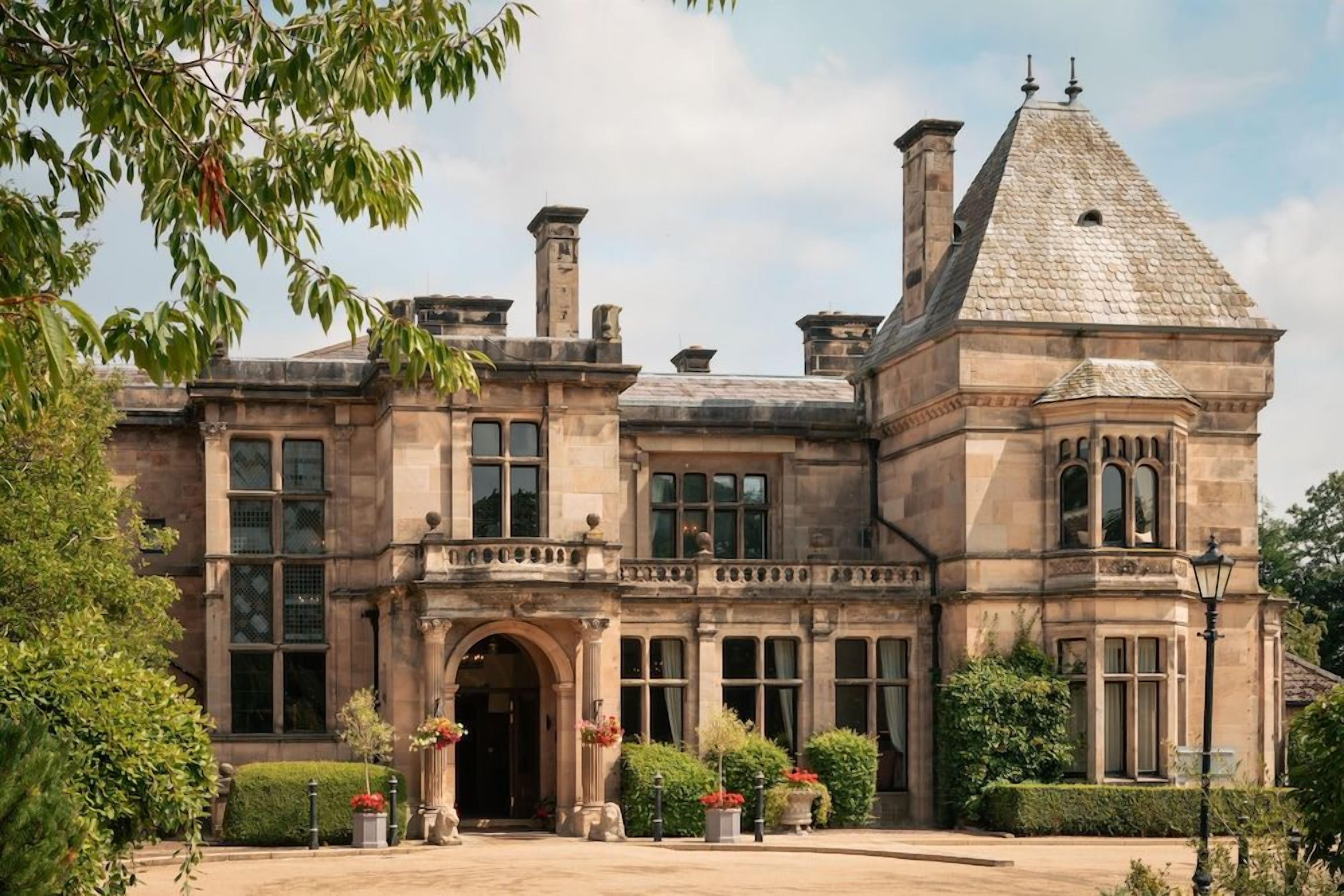 A historic building with a prominent entrance, large windows, and a distinctive tower.