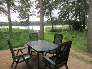 A deck with a table and chairs overlooking a lake. - B 1 Directly at Lake Netzen (Kloster Lehnin)