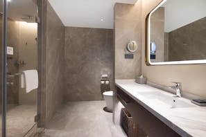 A modern bathroom with a glass shower enclosure, a large mirror, and a white sink. - Home2 Suites BY Hilton Xingwen Yibin (Yibin)