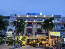 Un edificio de varios pisos con un llamativo letrero de 'Motel 6'.