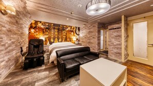 A modern hotel room with a bed, massage chair, and a seating area. - Hotel Luna Modern Sakuranomiya (Osaka)