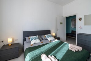 A modern bedroom with a bed, nightstands, a dresser, and a door leading to another room. - A spacious apartment of approximately 100 sqm, accommodating up to 7 people and laid out over two floors (with internal stairs leading to the upper level).The property is located in Tordandrea, a quiet hamlet of Assisi, in an area with good local ameniti (Tordandrea)