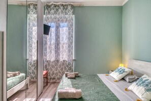 A bedroom with a bed, a chair, a small table, and a window with curtains. - A spacious apartment of approximately 100 sqm, accommodating up to 7 people and laid out over two floors (with internal stairs leading to the upper level).The property is located in Tordandrea, a quiet hamlet of Assisi, in an area with good local ameniti (Tordandrea)