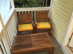 A wooden balcony with two chairs and a table. - Spacious 3BR Crescent Hill Apt | Yard & Parking (Louisville)