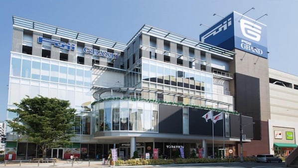 A multi-story building with a prominent '6' sign, indicating it might be a hotel or a large commercial building. - Hotel Legit Hiroshima (Hiroshima)