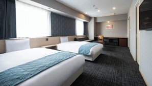 A hotel room with two beds, a desk, a chair, and a television. - Hotel Legit Hiroshima (Hiroshima)