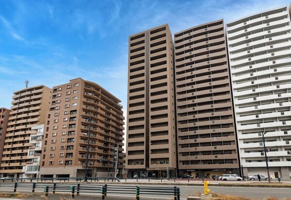 A row of high-rise residential buildings with multiple floors and balconies.