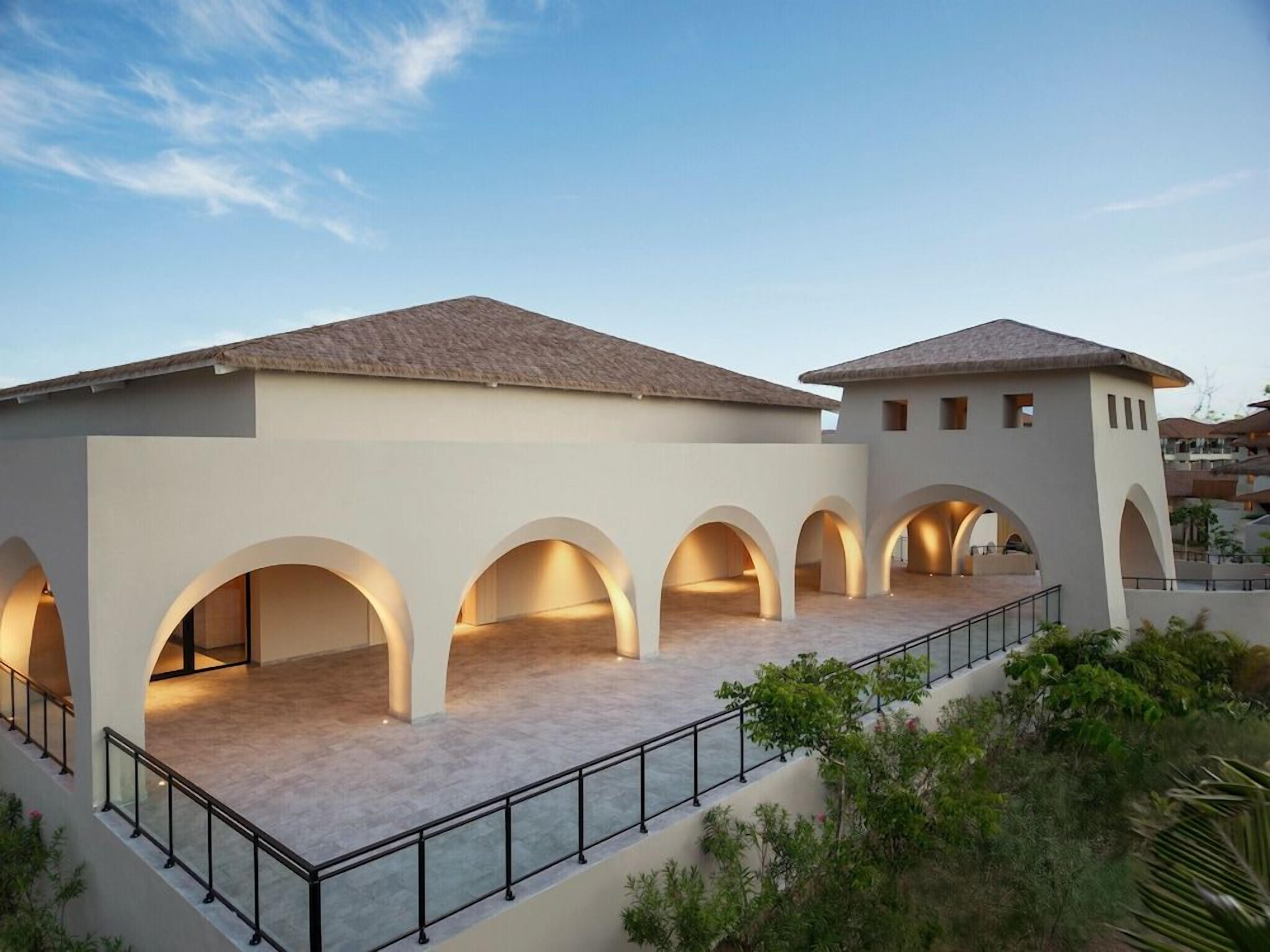 A building with multiple arched openings and a flat roof.