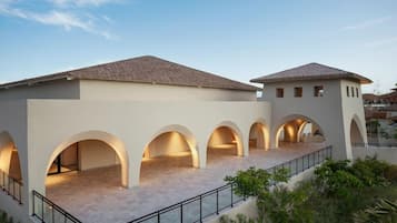 A building with multiple arched openings and a flat roof.
