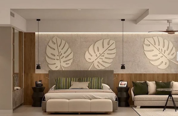 Un dormitorio moderno con una cama grande, un sofá y una pared con motivos de hojas.