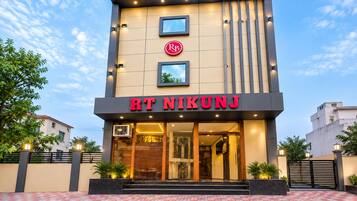A modern building with a sign that reads 'RT NIKUNJ'.