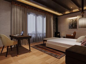 A modern bedroom with a bed, a desk, a chair, and a lamp. - Taj Gangtey Resort & Spa, Bhutan (Wangdue Phodrang)