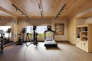 A gym with exercise equipment, a water dispenser, and a large window.