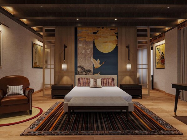 Un dormitorio con una cama grande, dos mesitas de noche, una silla, un cuadro grande en la pared y una alfombra estampada.