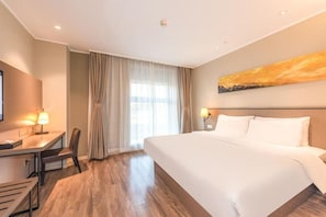 A hotel room with a large bed, a desk with a chair, a TV, and a window with curtains. - Homeinn Plus (Beijing)