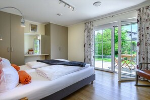 A bedroom with a bed, a window, and a view of the outdoors. - Holiday apartment with 3 bedrooms (Garmisch-Partenkirchen)