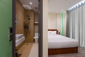 A hotel room with a shower, toilet, and a bed. - V'luna Hotel - Managed by THM (Can Tho Municipality)