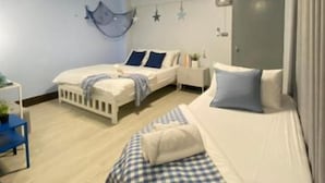 A bedroom with two beds, a bedside table, a chair, and a window. - Triple J Hotel Trang (Trang)