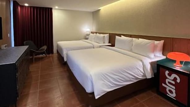 A hotel room with two beds, a desk, and a minibar. - Aksara Hotel by Aruna Group (Bandung)