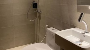 A bathroom with a toilet, sink, and shower. - Aksara Hotel by Aruna Group (Bandung)