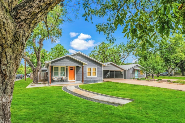 A residential property with a well-maintained lawn, a driveway, and a garage.