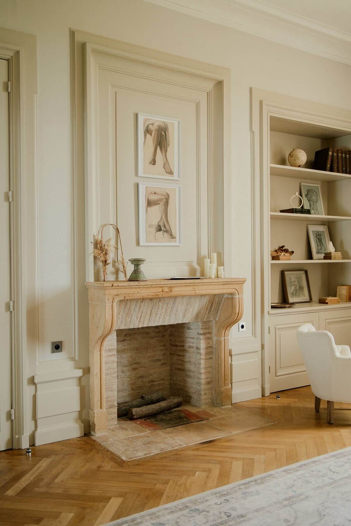 A room with a fireplace, a bookshelf, and a chair.