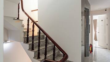 Un interior moderno con una escalera de madera, un tragaluz y un diseño minimalista y limpio.