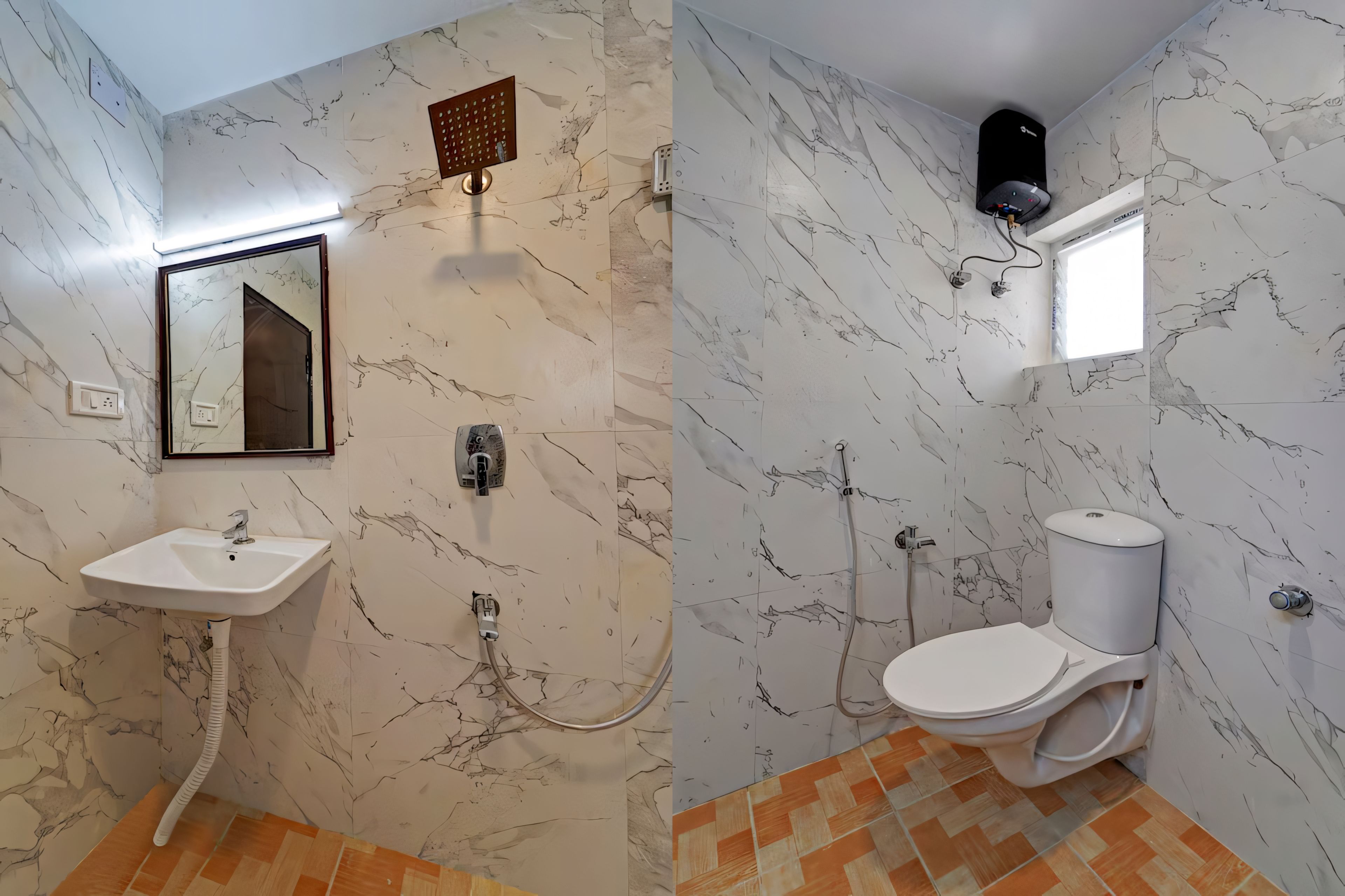 A bathroom with a marble wall, a sink, a toilet, and a shower.