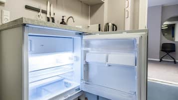 An open refrigerator with multiple shelves and a freezer compartment.