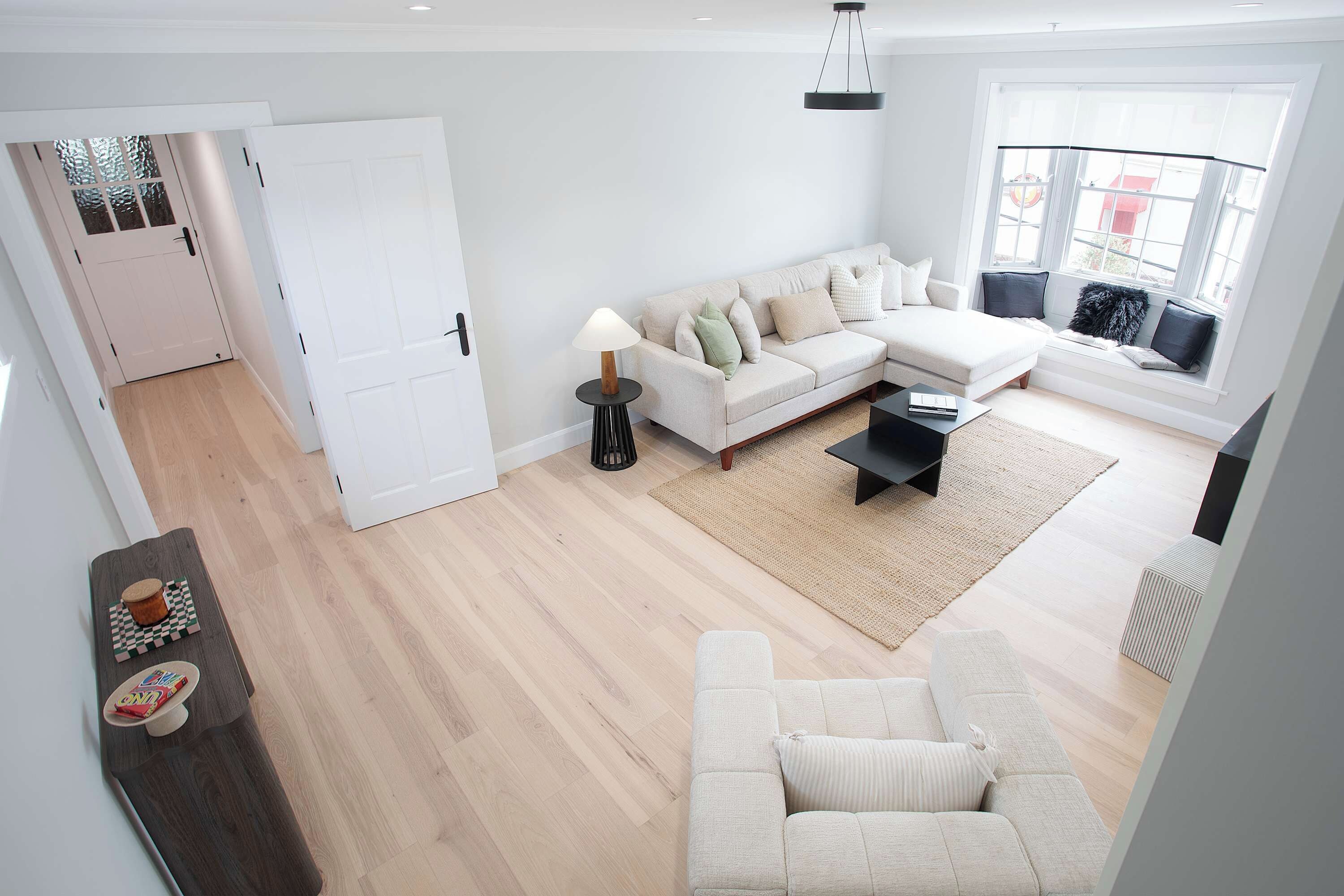 A modern living room with a sofa, a coffee table, and a lamp.
