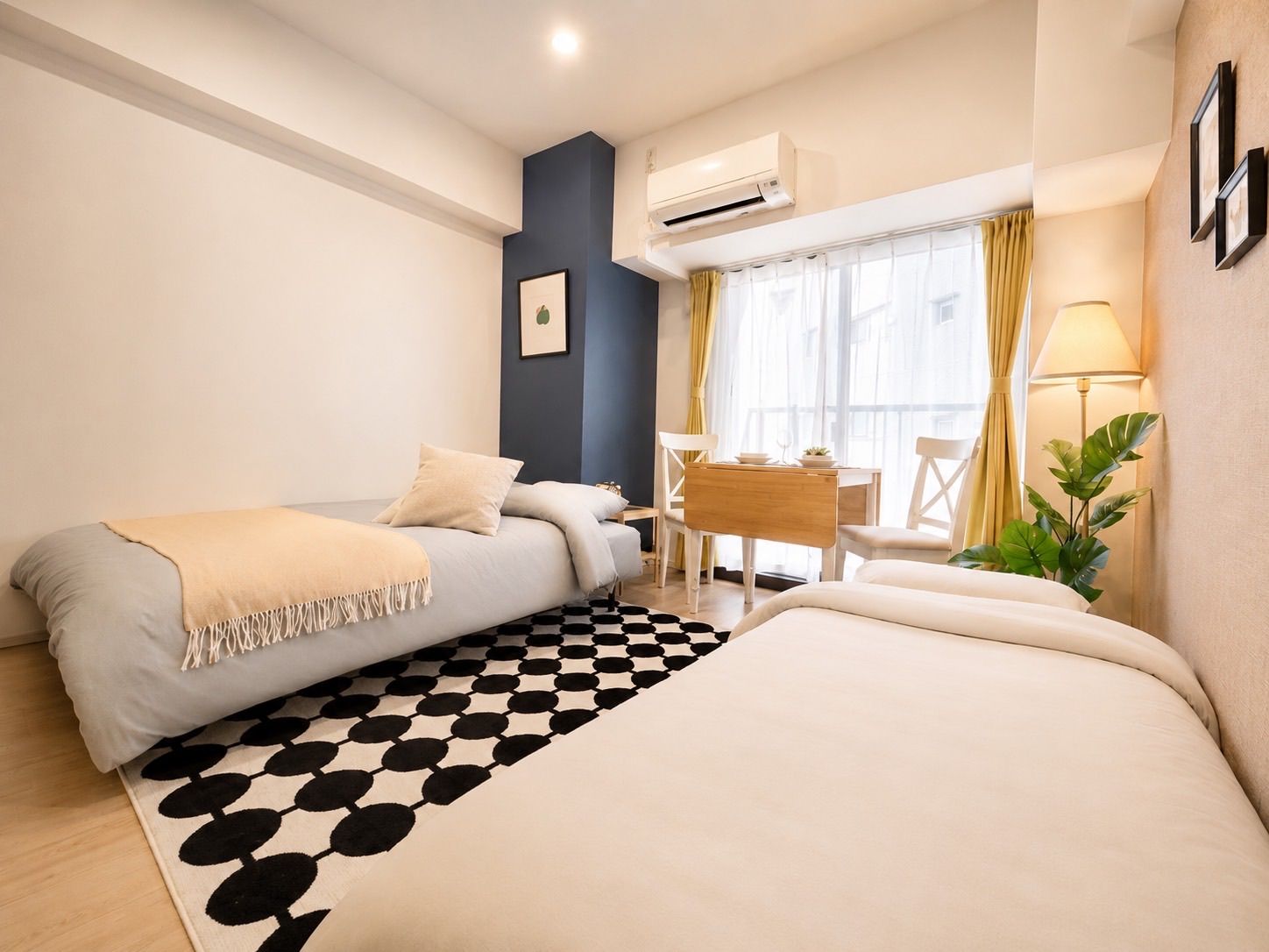 A compact hotel room with a bed, a desk, and a chair.